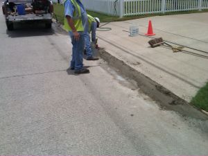 Men evening concrete on road