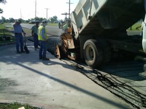 Dumptruck on road pouring material